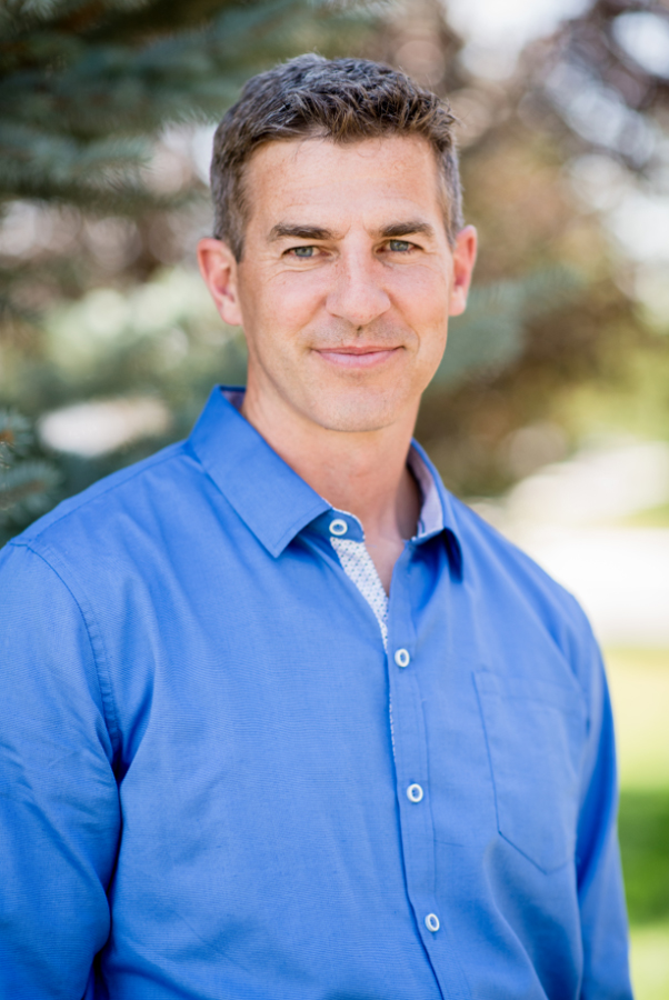 portrait of Dr. Redd, white man with salt and pepper hair wearing blue shirt, standing outside